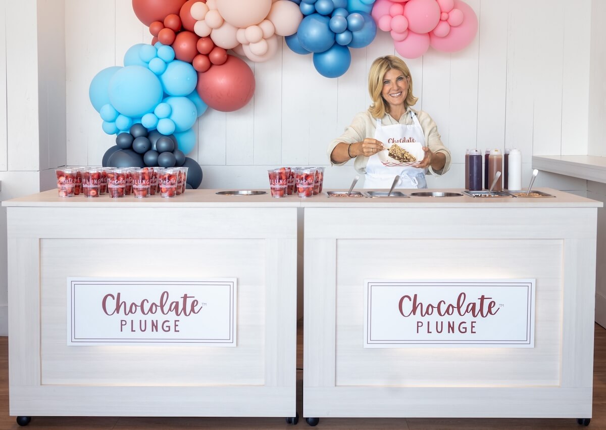 two chocolate plunge catering carts with franchise owner Donna behind the right hand cart