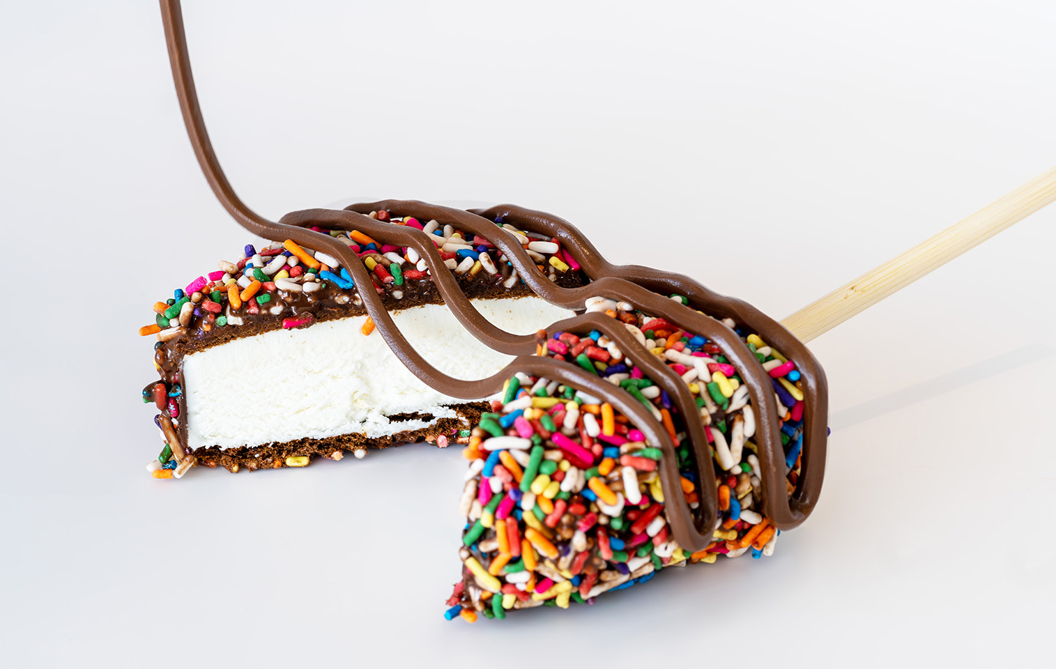 Vanilla ice cream sandwich, dipped in chocolate and covered in sprinkles