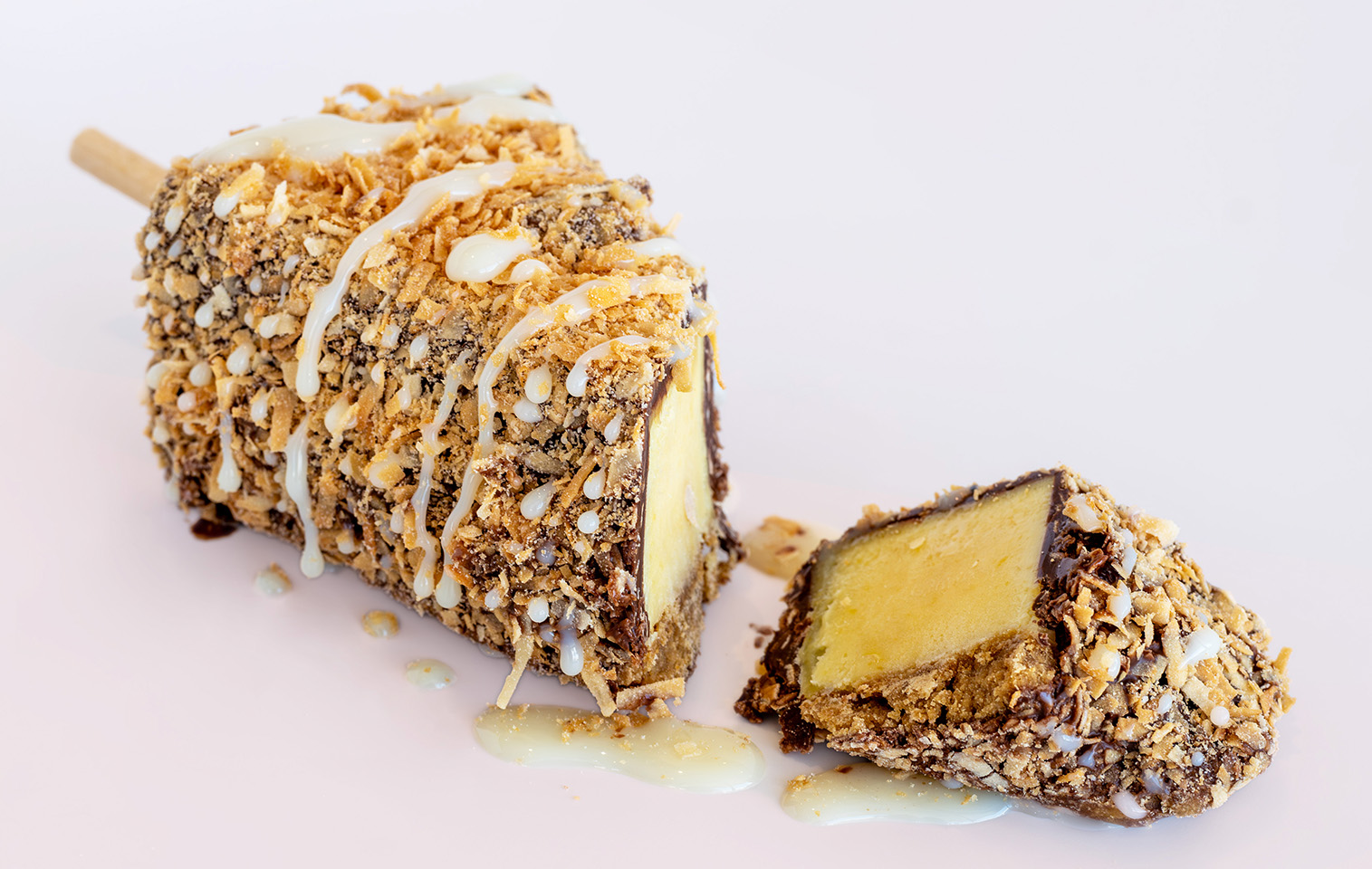 key lime pie, dipped in chocolate then covered in almonds and topped with sweetened condensed milk